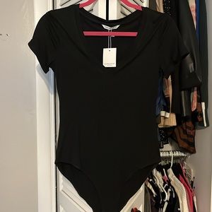 NWT short sleeves black bodysuit from Mango. SZ small with stretch.